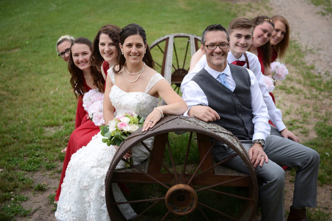 Weddings S&T Wedding party on wagon wheel bench